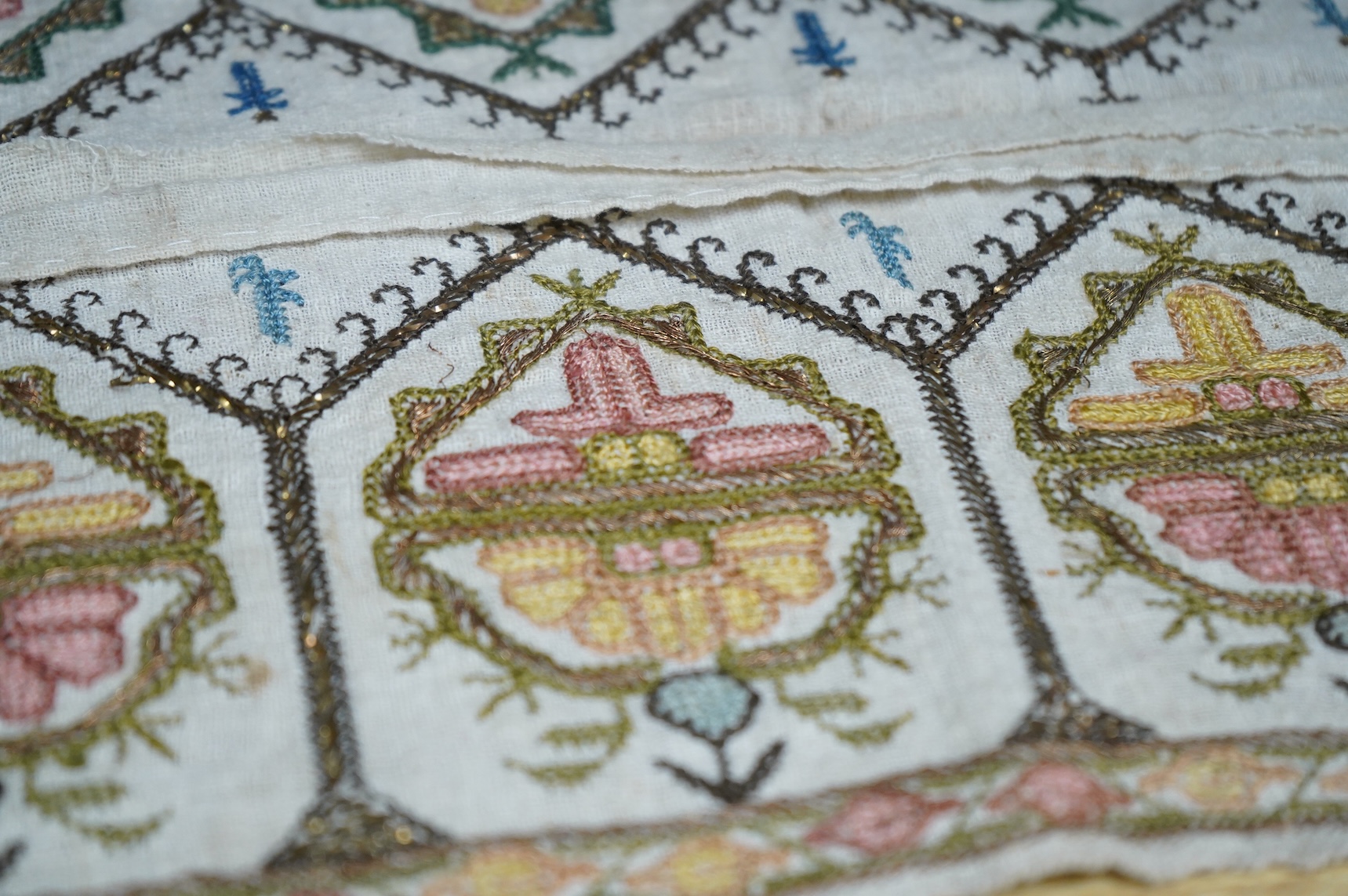 Two 19th century Turkish hand embroidered towel ends sewn together later as a table centre. Worked on fine hand woven linen in polychrome silks with gold metallic thread fillings, 39.5cm wide x 26.5cm deep. Condition - t